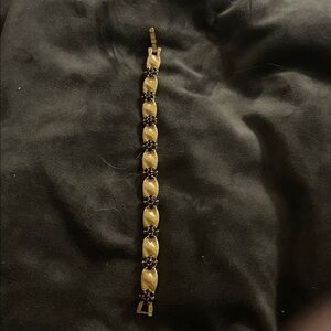 Vintage Crown Trifari brushed gold tone and red rhinestones. 7 inches long